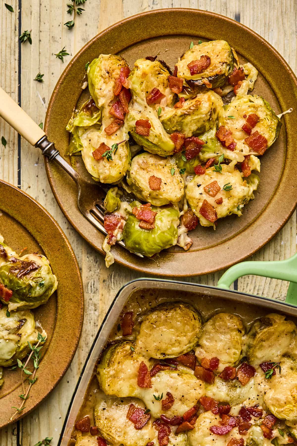 a scoop of brussels sprouts topped with bacon on a plate 