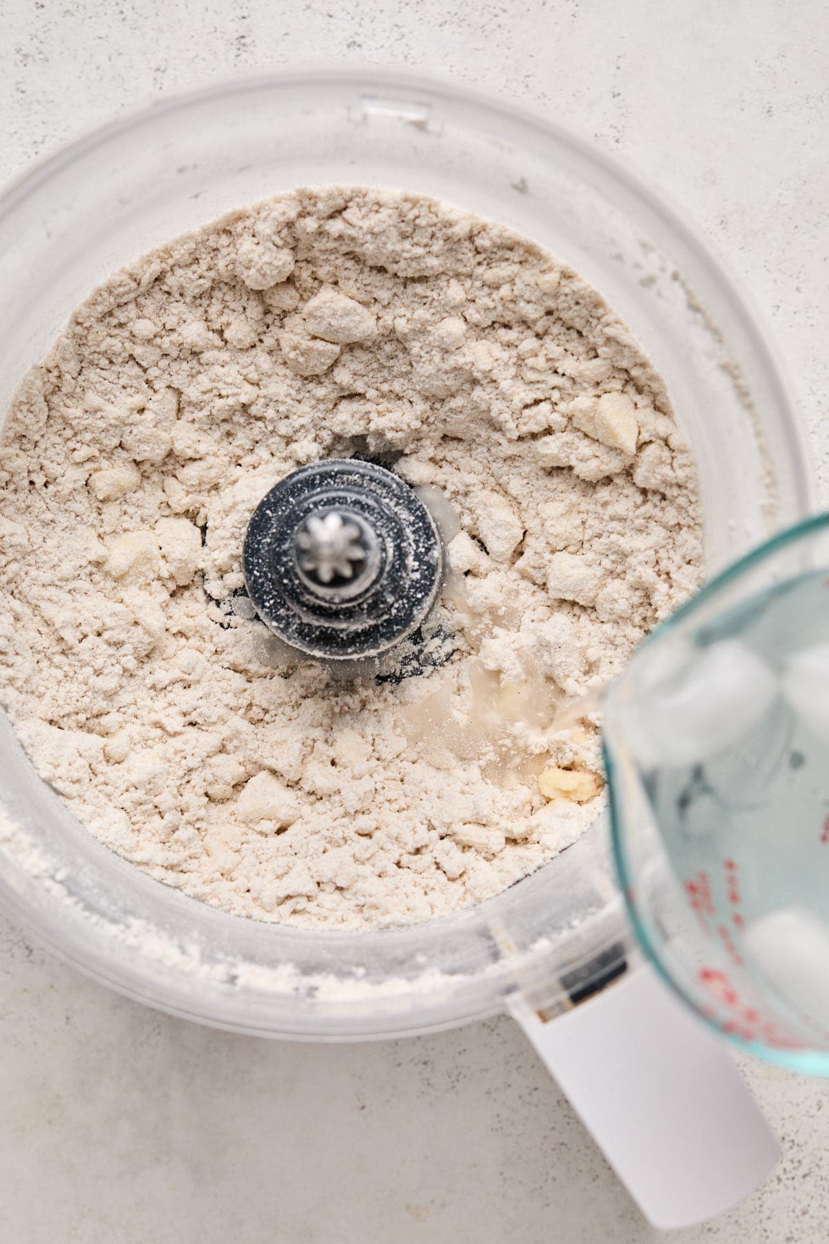 pouring water and vinegar into the flour mixture 