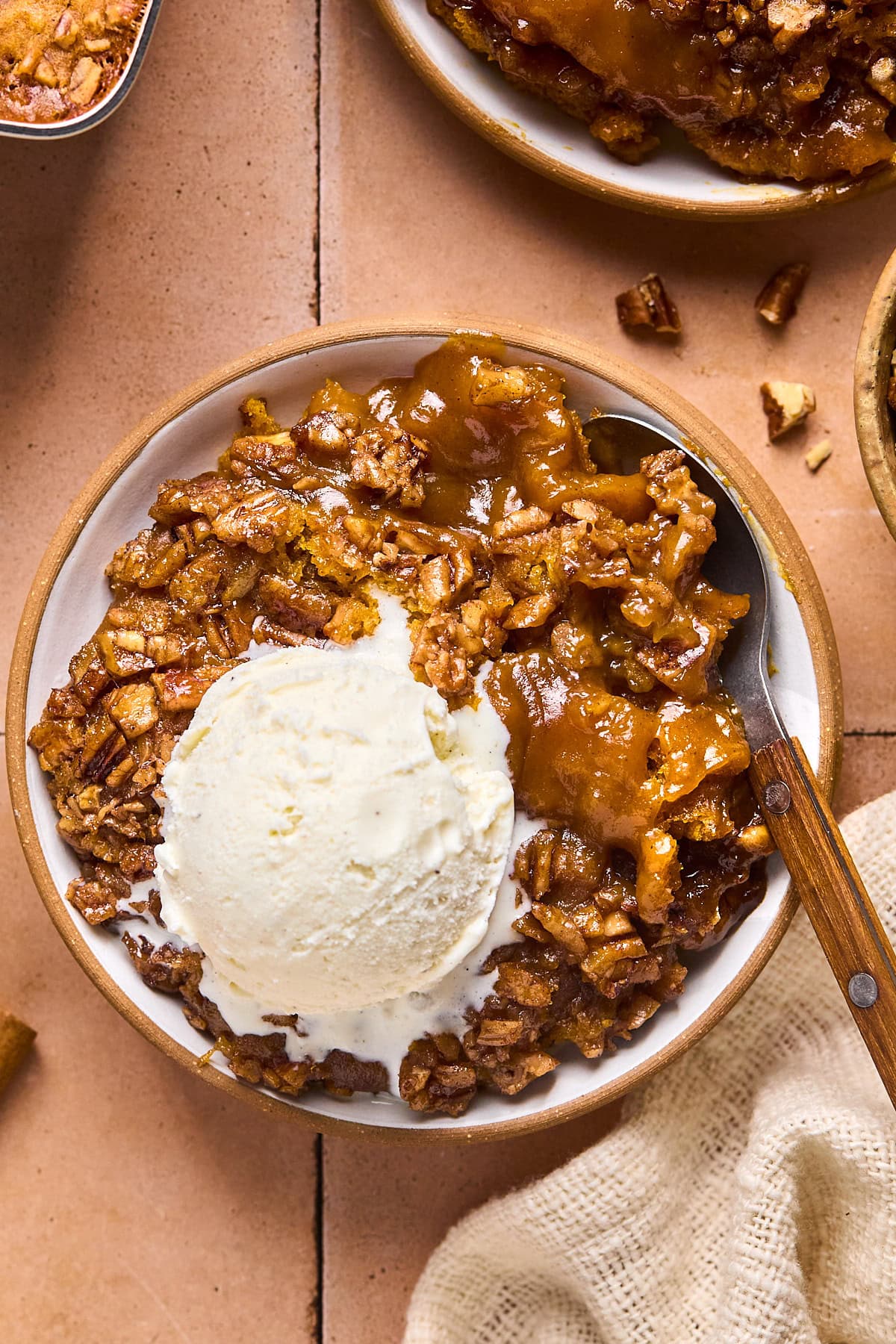 a bowl with pumpkin cobbler and vanilla ice cream