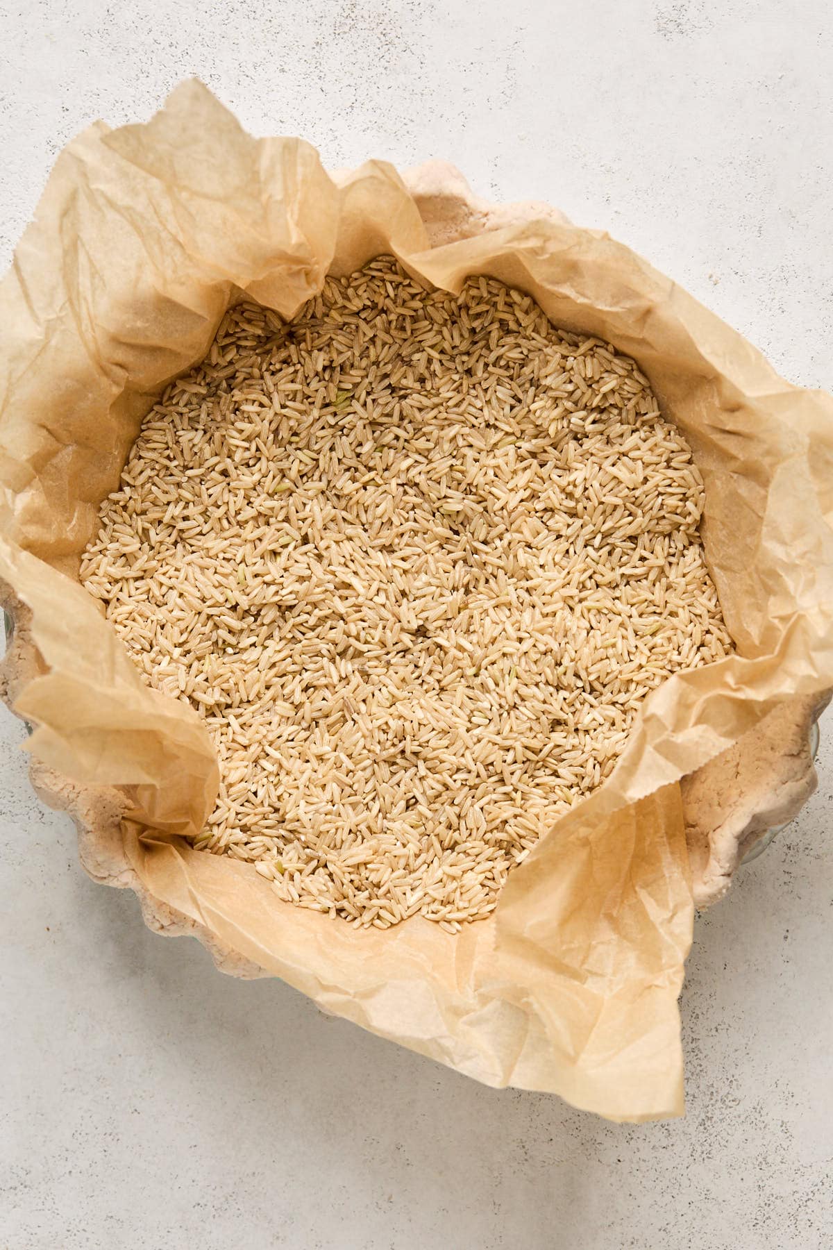 parchment paper and rice in a pie crust to blind bake 