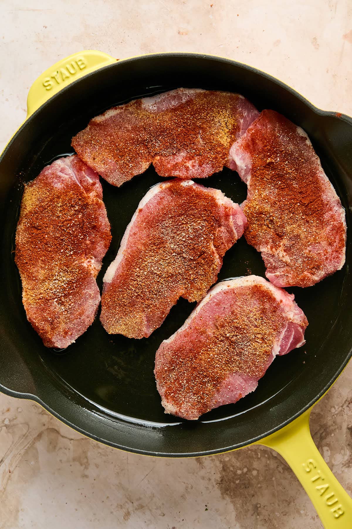 pork chops in a cast iron skillet. 