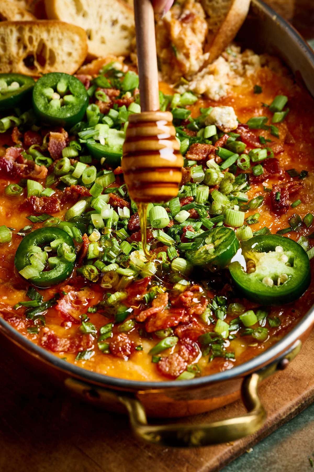 drizzling honey onto a baked dip 