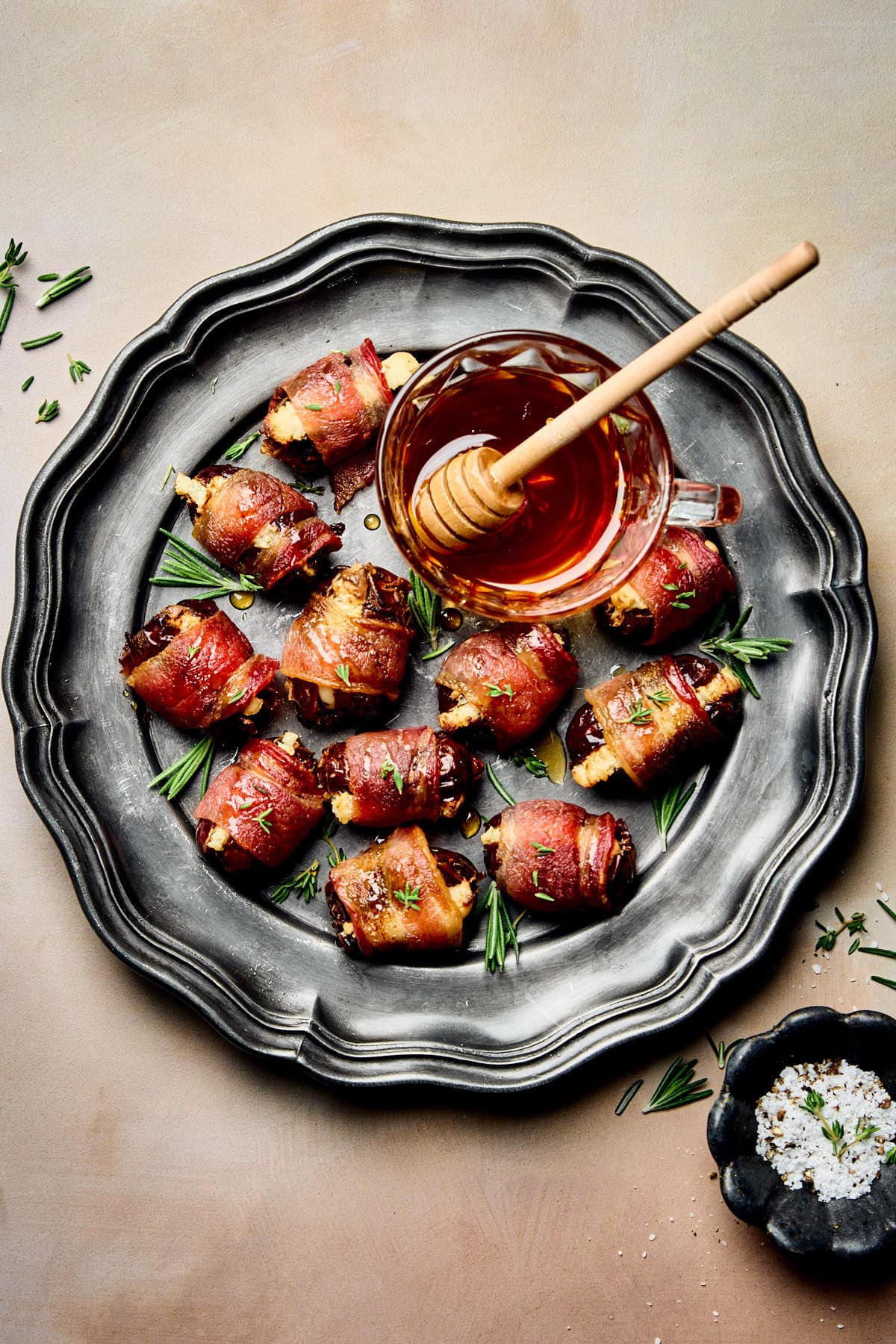 a platter filled with stuffed dates wrapped in bacon