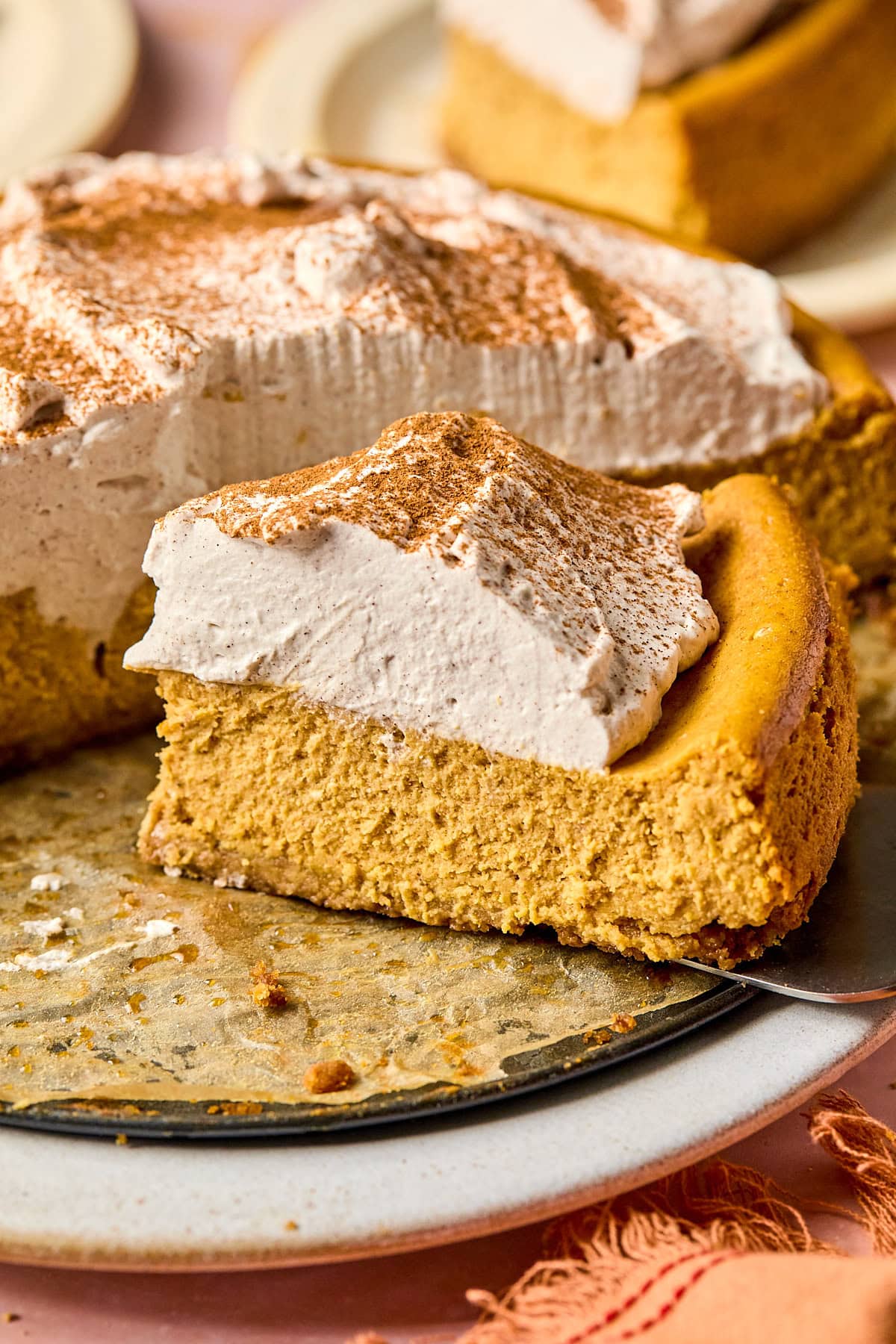 a slice of gluten free pumpkin cheesecake on a tray.