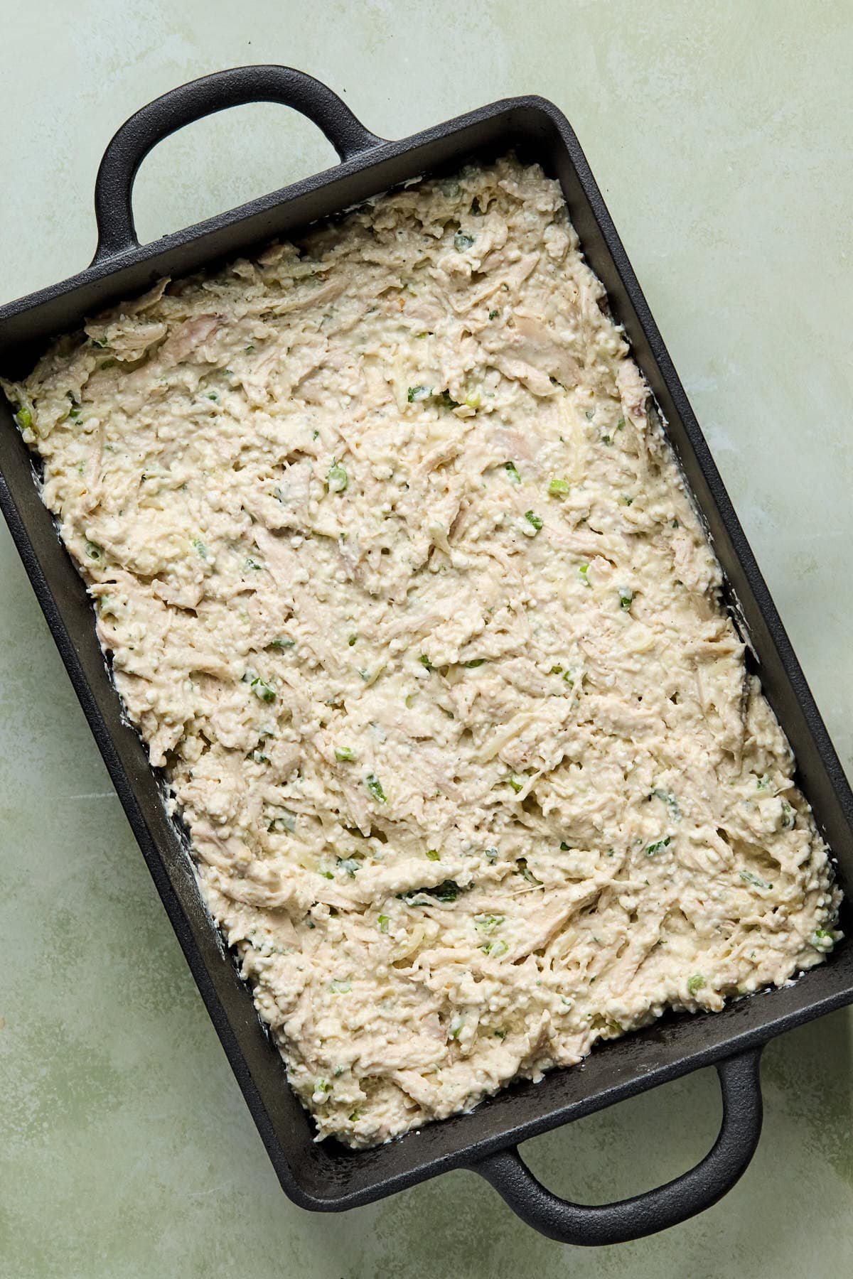 the chicken mixture spread into a baking dish 