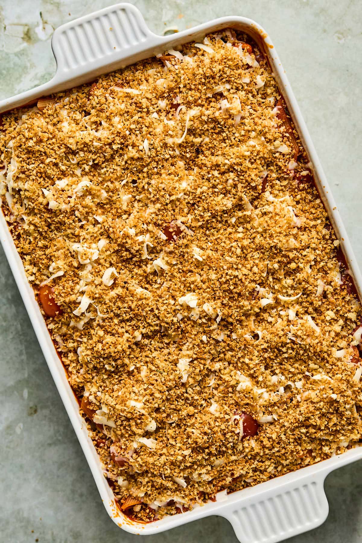 a casserole topped with bread crumbs and mozzarella cheese