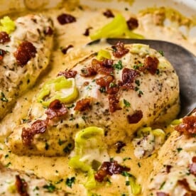creamy pepperoncini chicken in a skillet topped with bacon