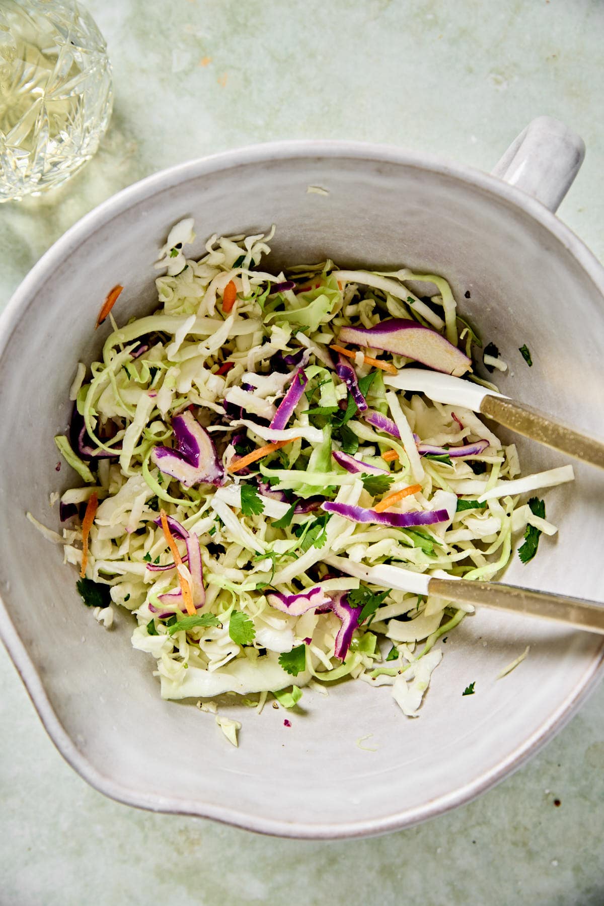 cilantro lime coleslaw in a white mixing bowl 