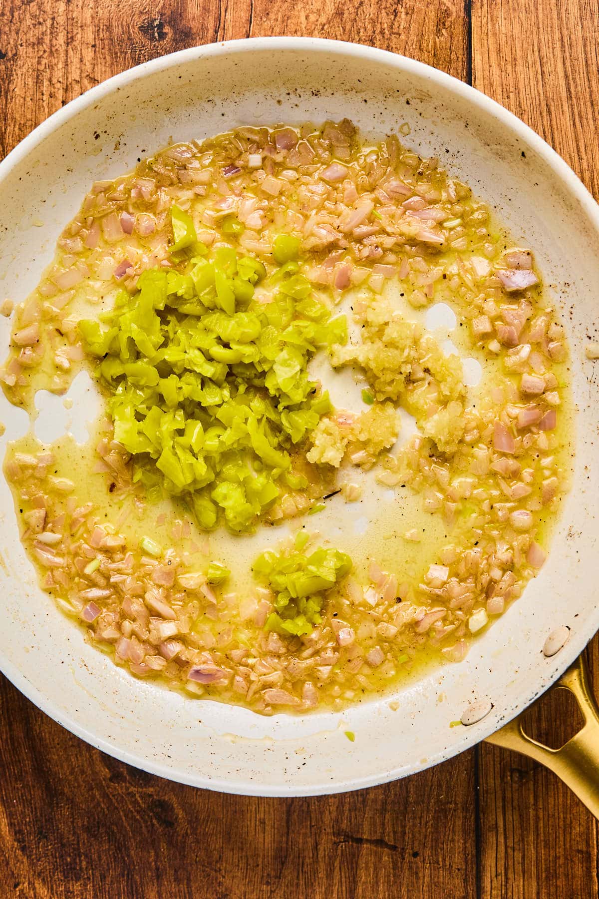 shallots and pepperoncinis in a skillet