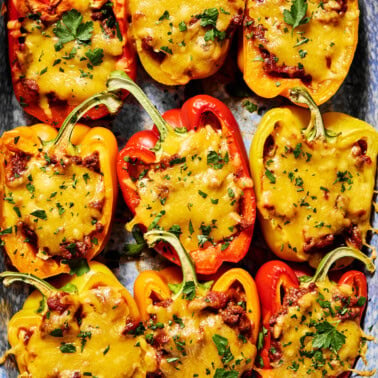 stuffed peppers topped with cheese and fresh herbs