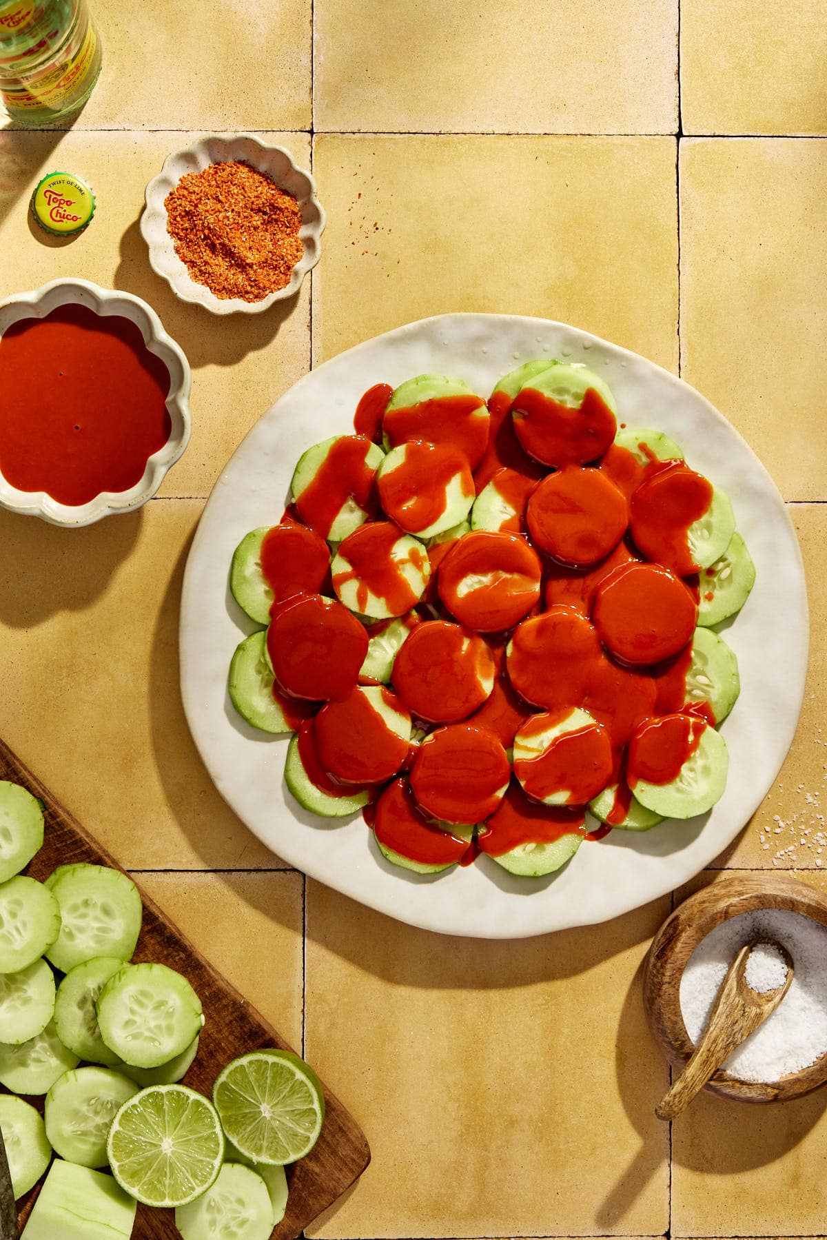 hot sauce drizzled on top of sliced cucumbers