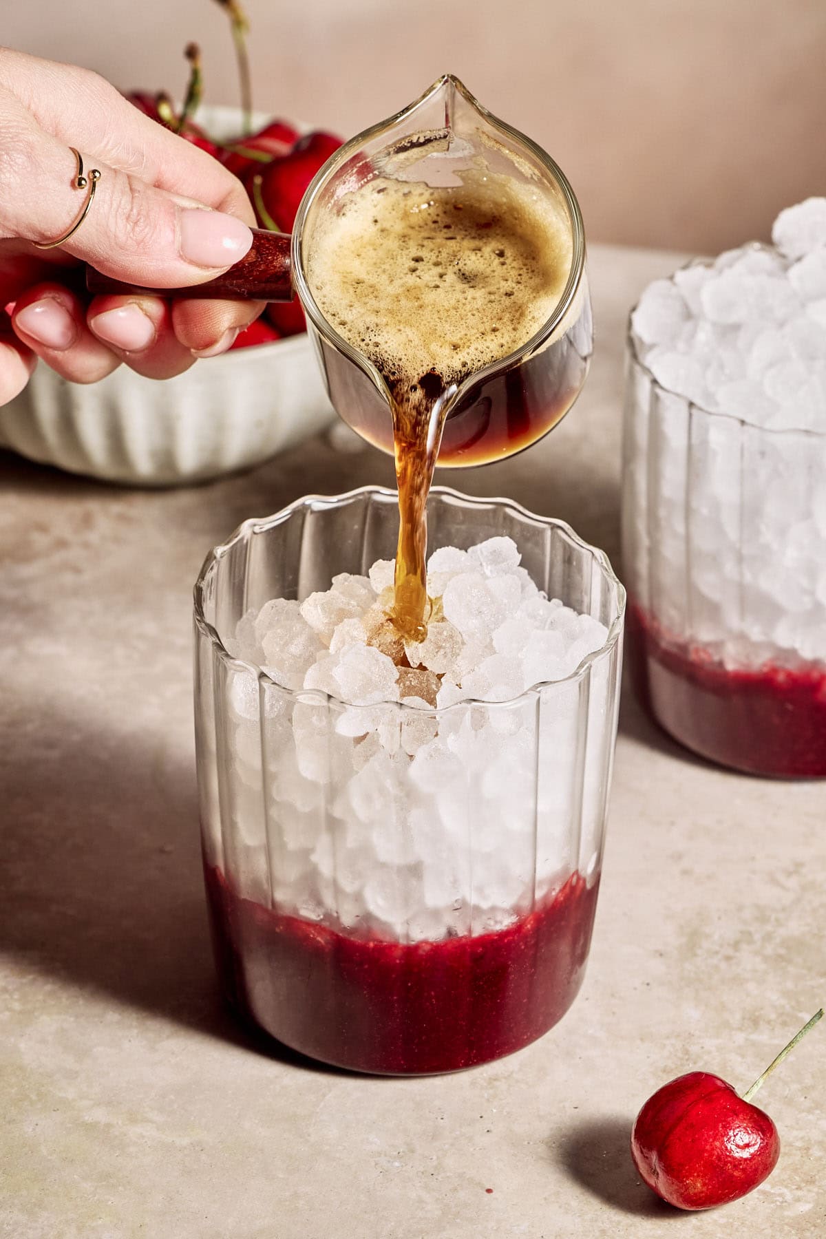 pouring espresso into a latte