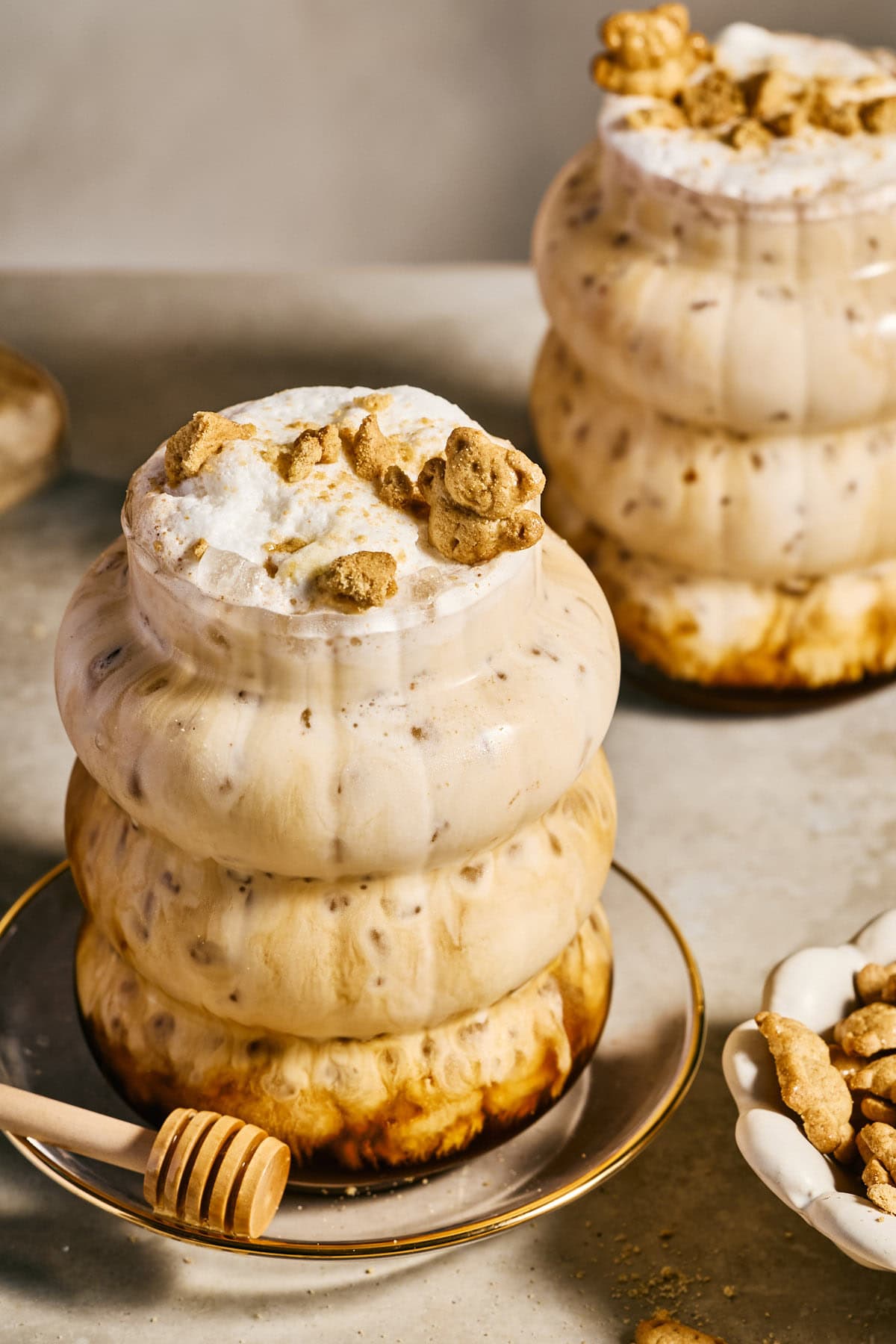 a teddy graham latte topped with foamy milk and teddy grahams