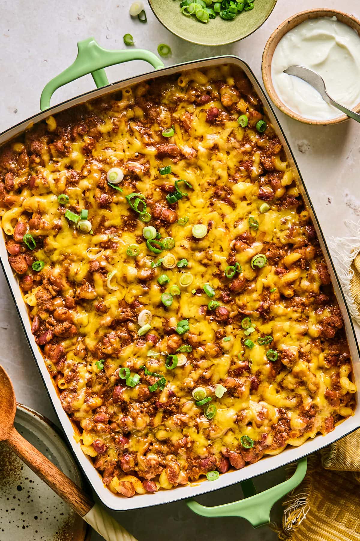 Cheesy leftover chili mac with pasta and green onion garnish