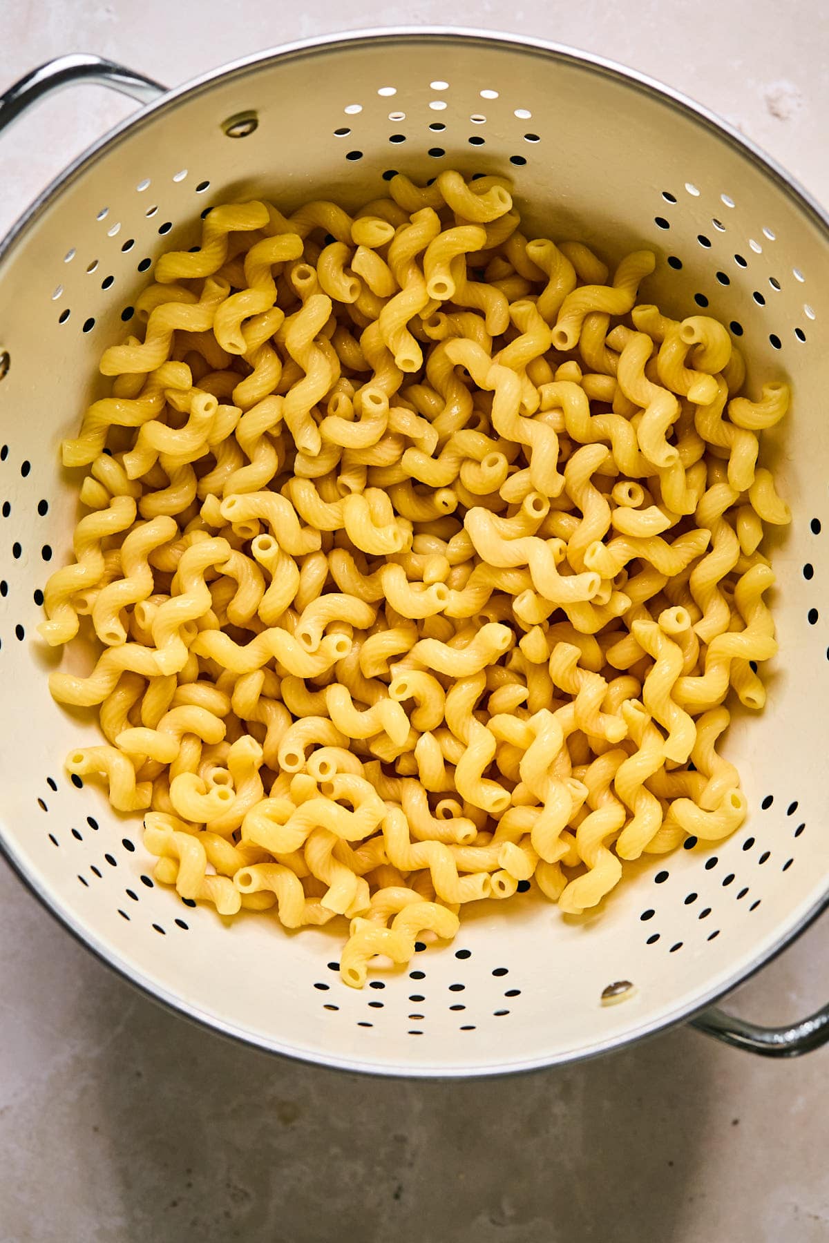 cooked pasta draining in a collander