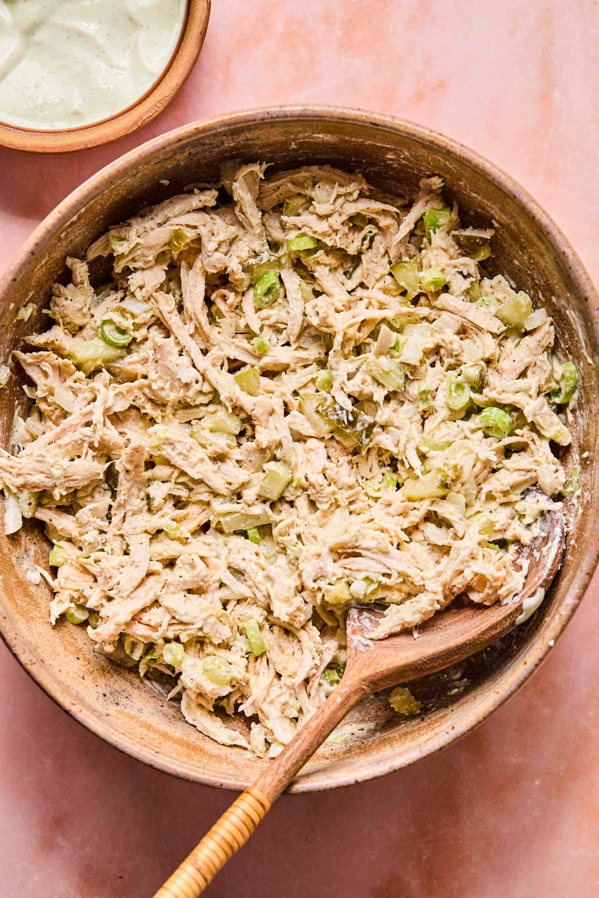 combined dill pickle chicken salad in a wooden bowl