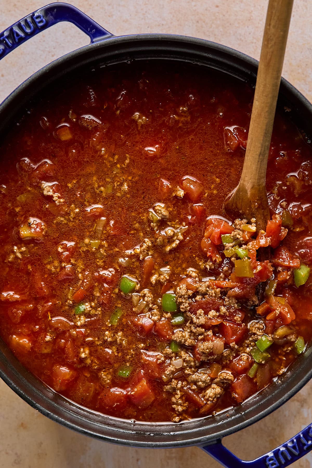 Broth, diced tomatoes, Rotel, and seasoning added to the pot and brought to a simmer.