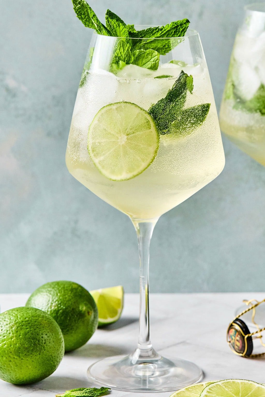 Finished Hugo Spritz garnished with mint and a lime slice, ready to serve.