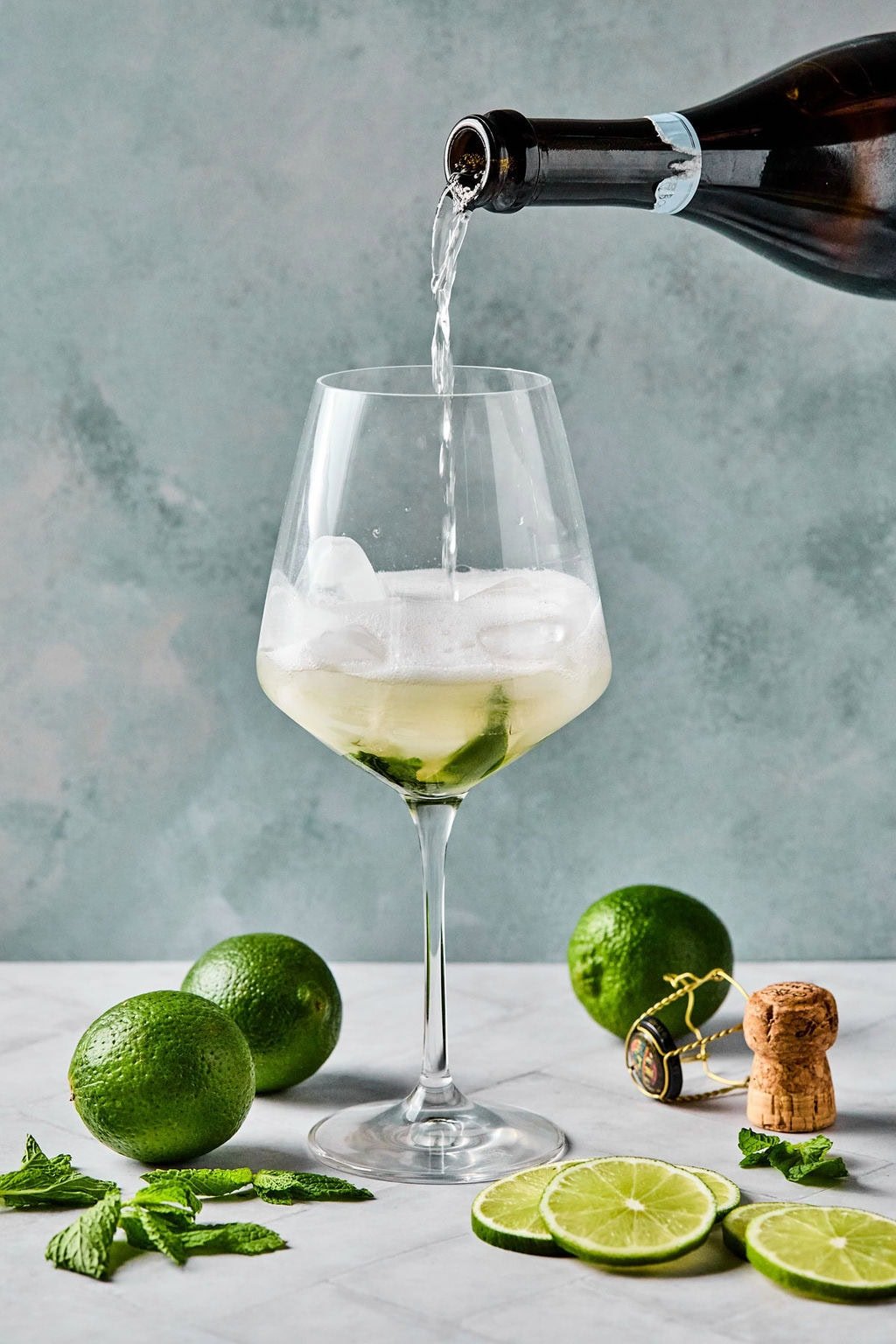 Topping the glass with prosecco before adding sparkling water for a Hugo Spritz.