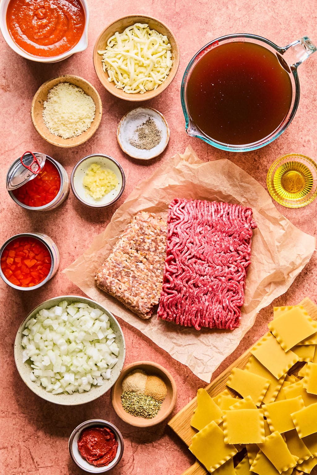 Ingredients for this lasagna soup recipe laid out on a clay colored countertop.