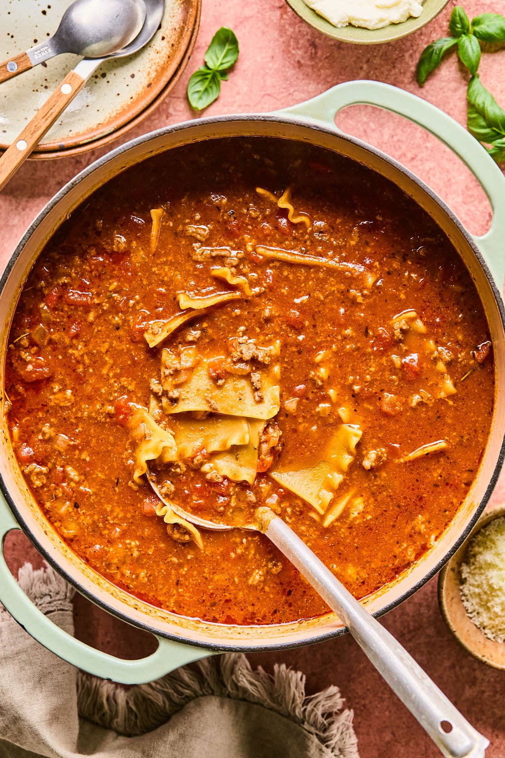 Lasagna soup recipe simmering in a large Dutch oven.