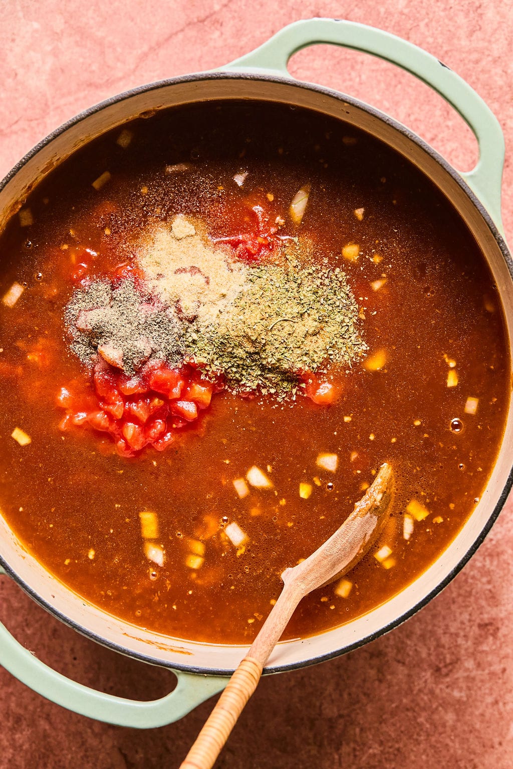 Diced tomatoes and broth in the Dutch oven with all seasonings. 