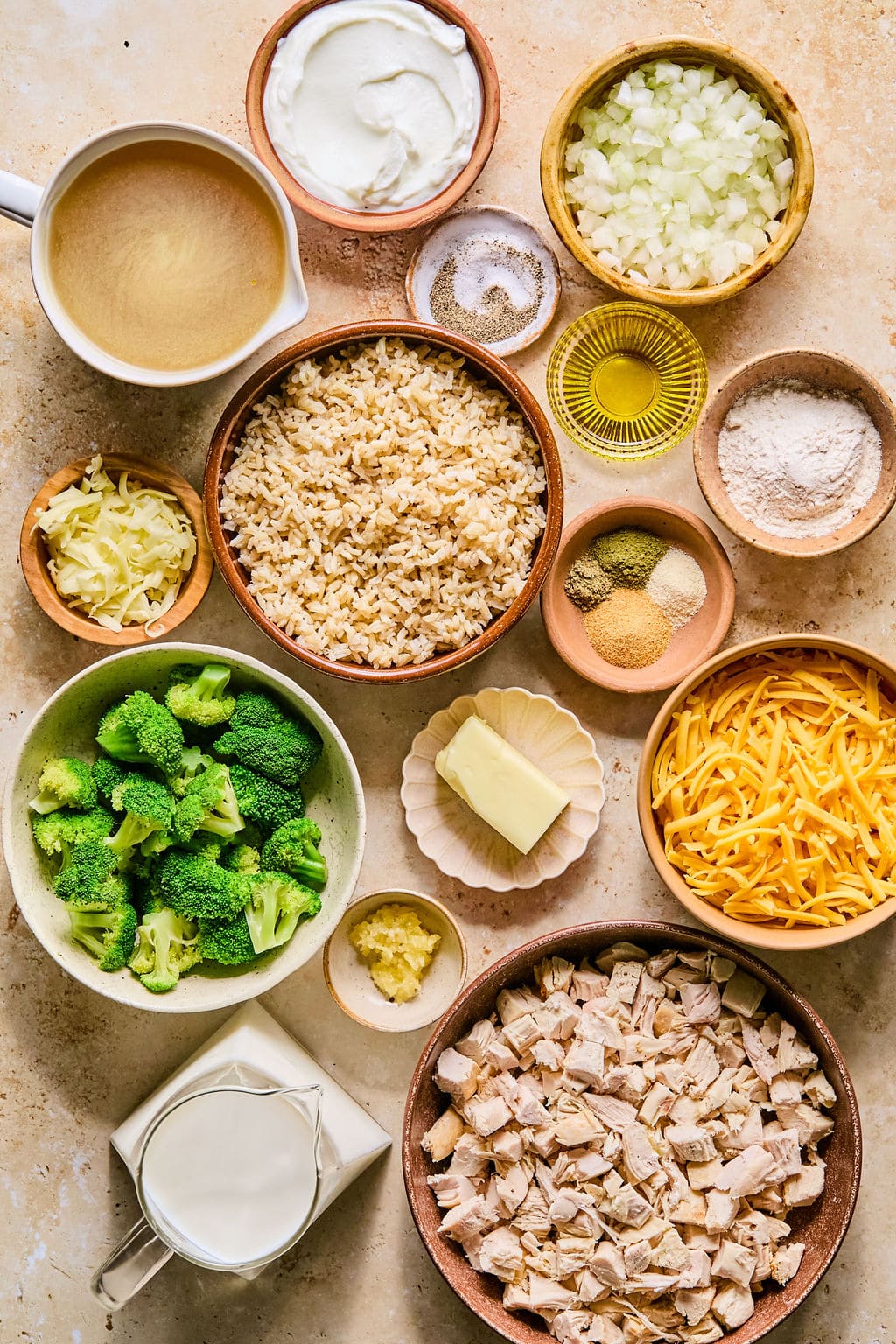Leftover turkey casserole ingredients laid out in bowls on a light colored countertop. 