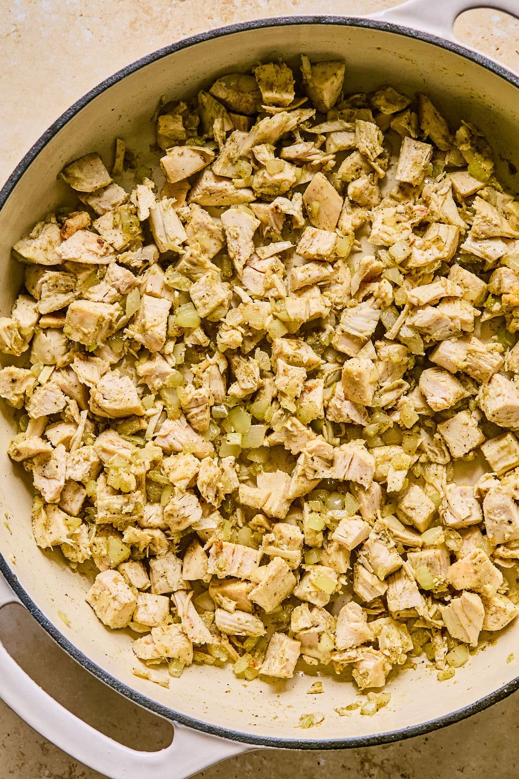 Leftover turkey in a large skillet with sautéed onion and garlic. 