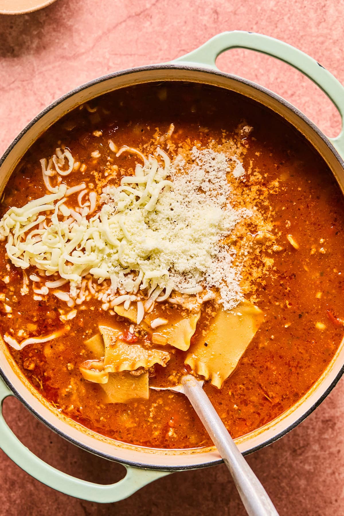 Mozzarella and parmesan being stirred into the soup.
