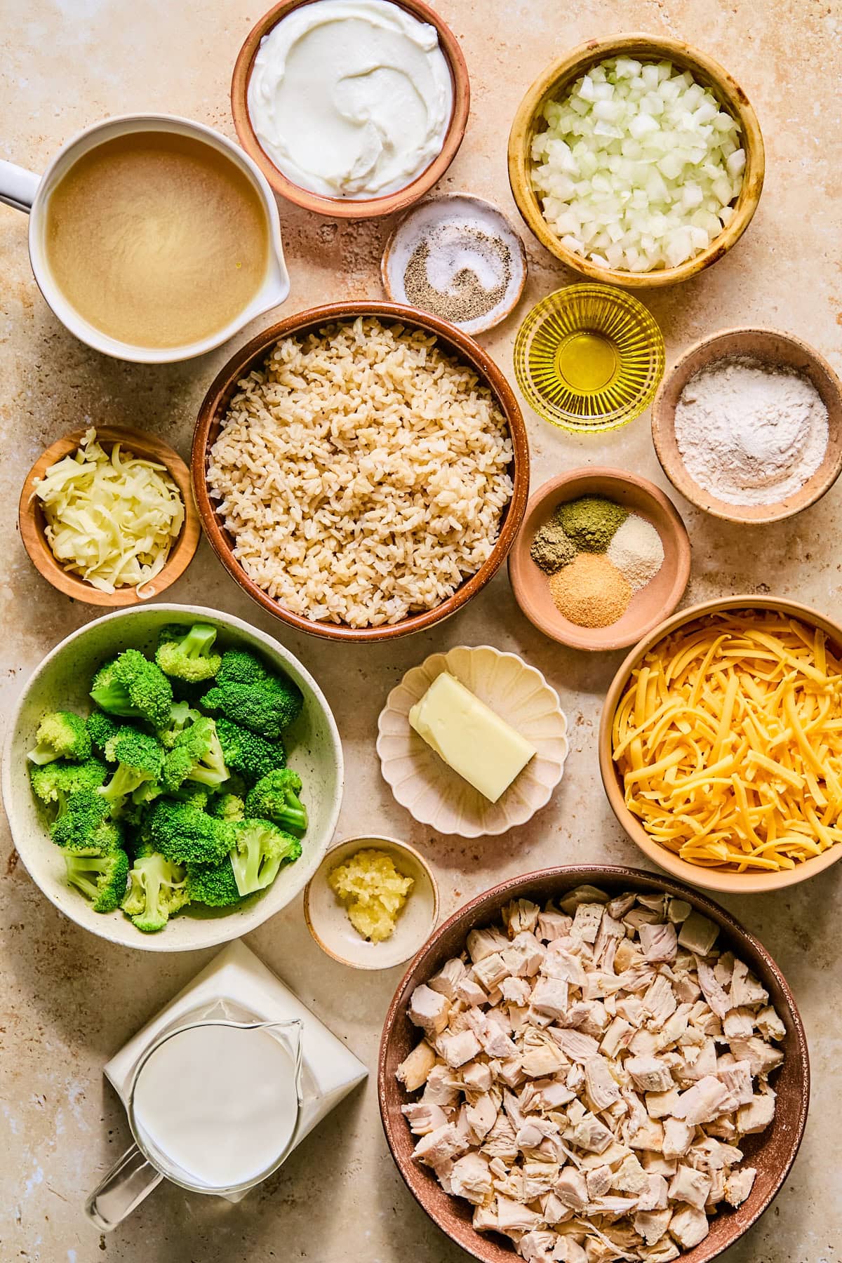Leftover turkey casserole ingredients laid out in bowls on a light colored countertop.