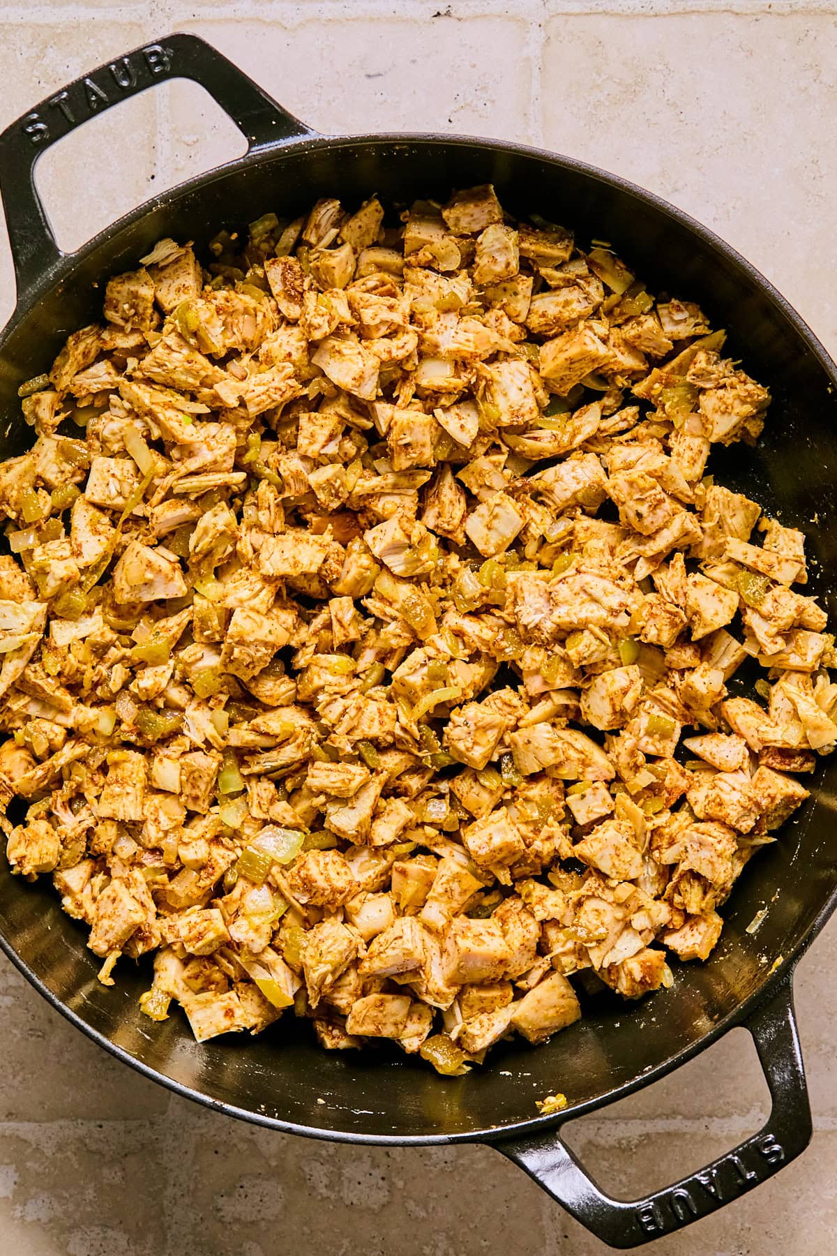 Chopped turkey and taco seasoning stirred into softened onions, garlic, and green chilies in a skillet.