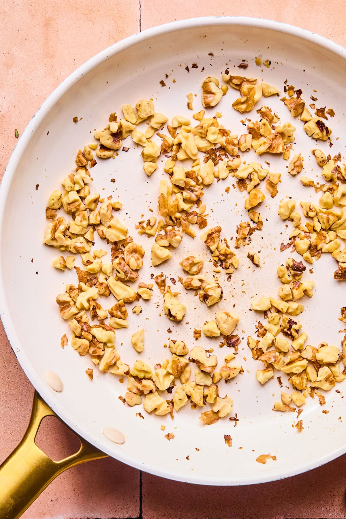 Chopped walnuts in a dry skillet on the stove.