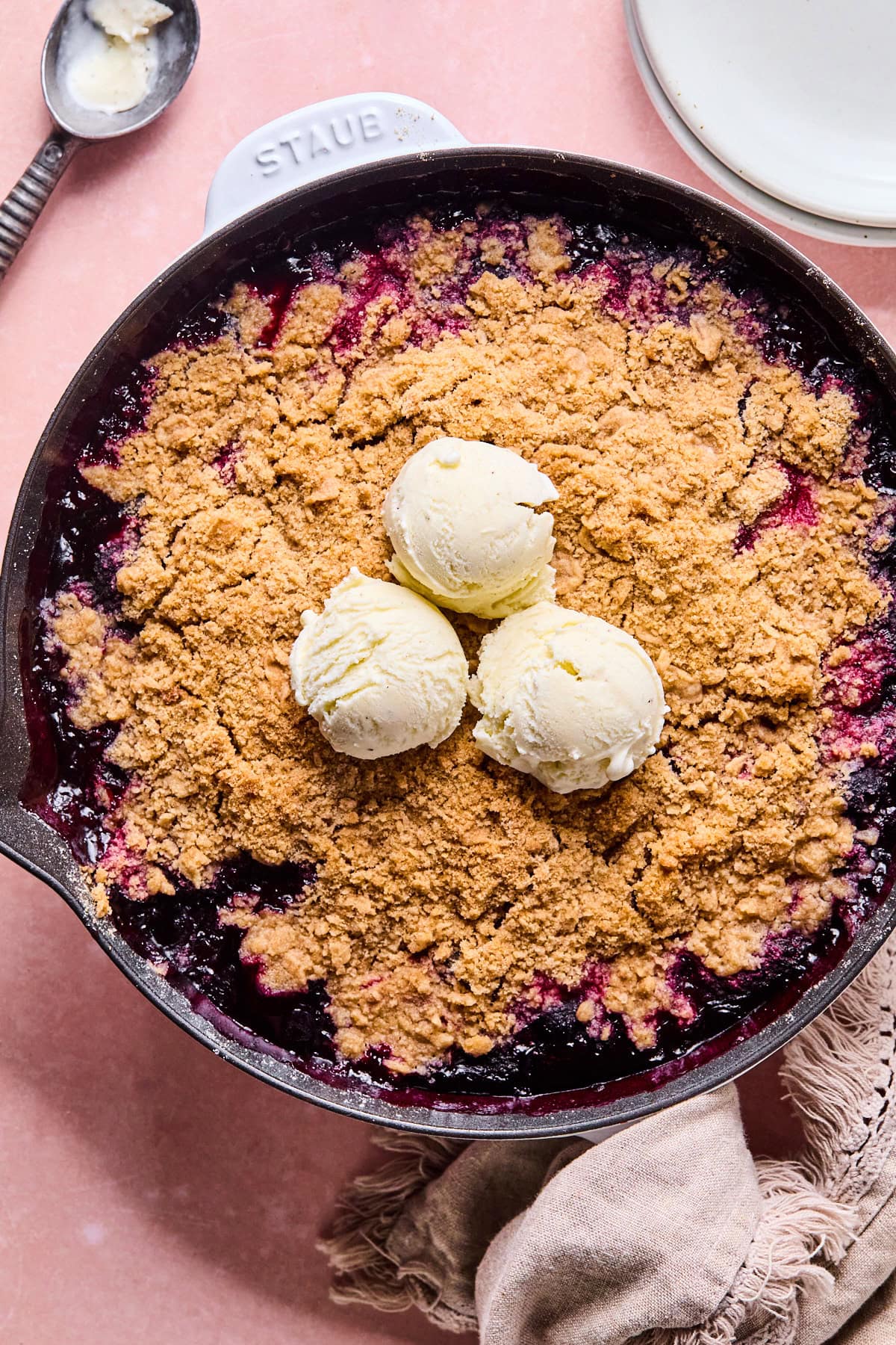 the cooked berry crumble topped with vanilla ice cream
