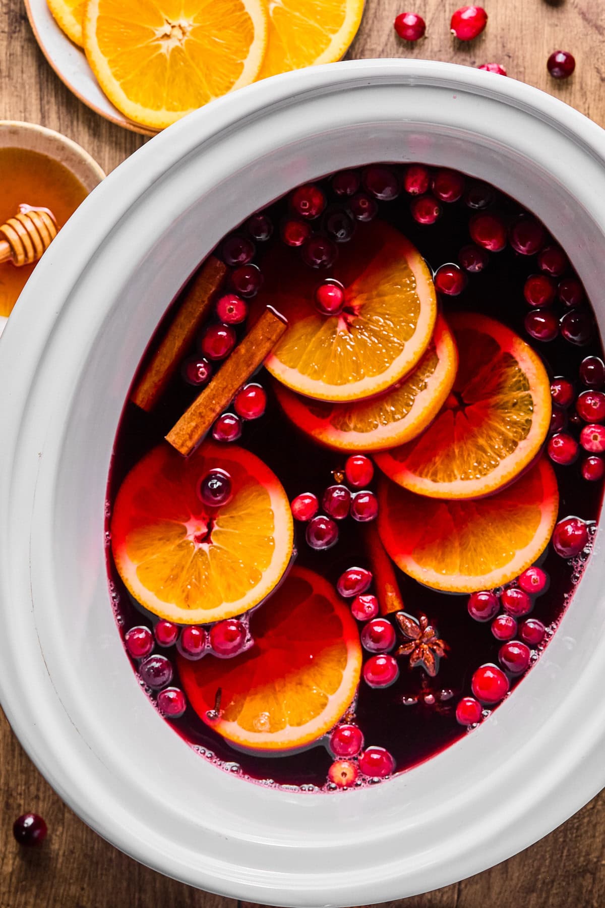 Non alcoholic mulled wine ingredients in a crock pot.