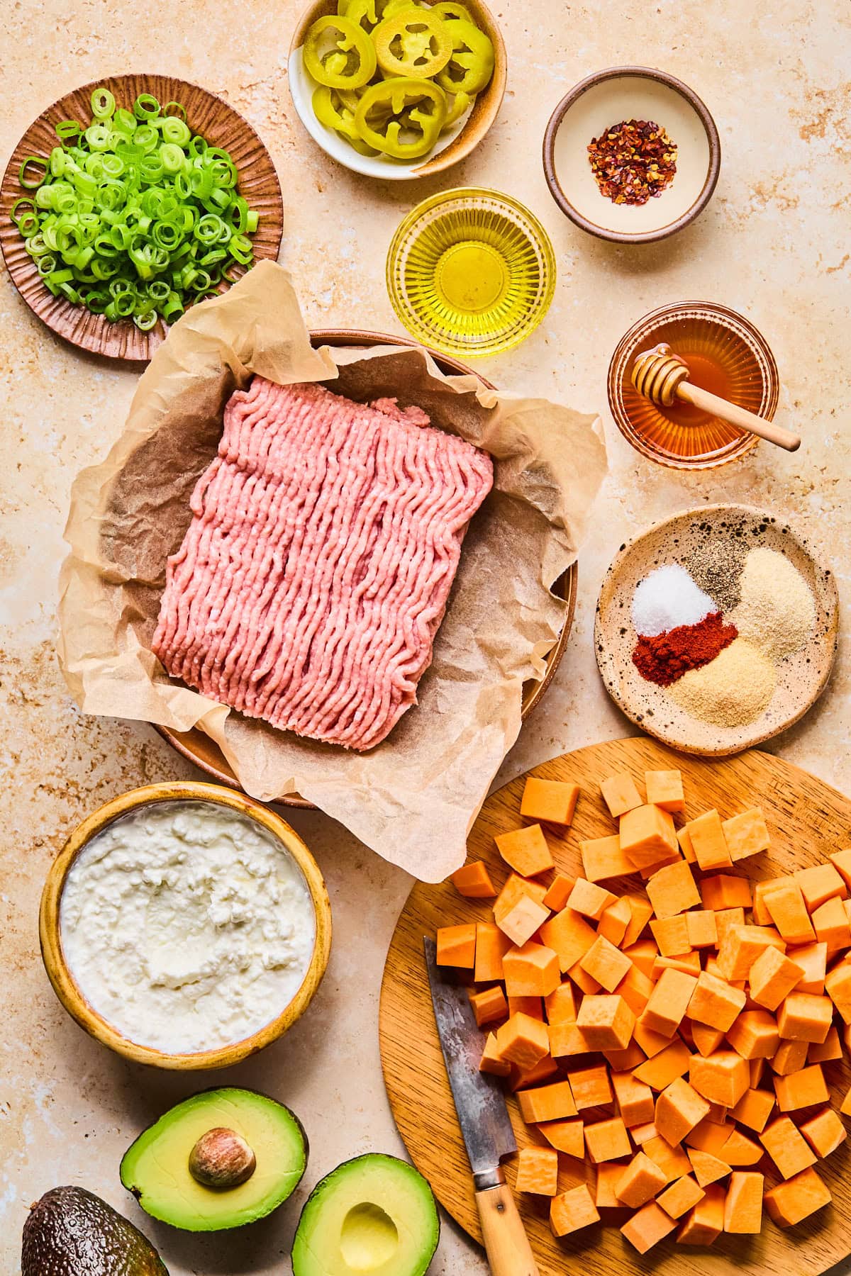 Cottage cheese bowls ingredients laid out in nesting bowls and plates on a light colored countertop.