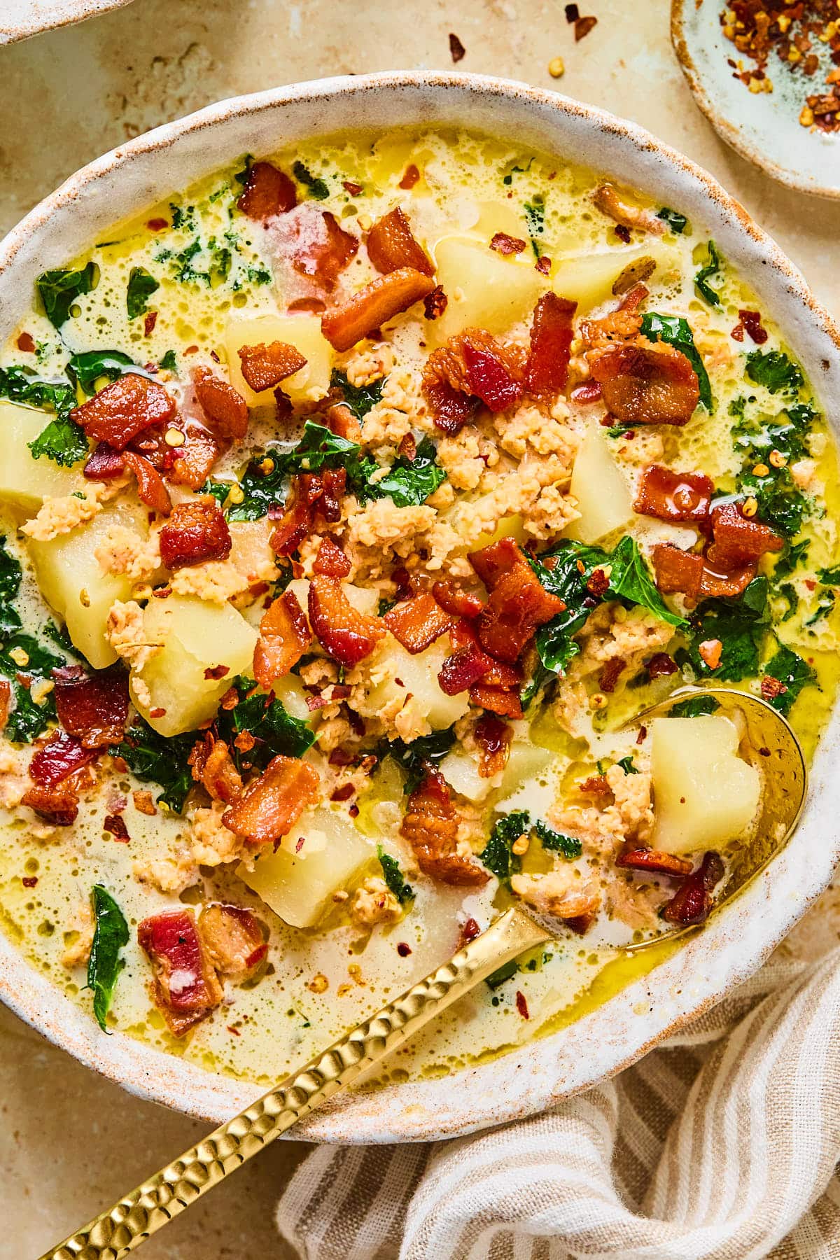 Close-up of a bowl of Instant Pot zuppa toscana with a spoon resting inside.