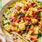 Close-up of instant pot zuppa toscana with a spoon resting inside of the bowl.