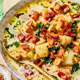 Close-up of instant pot zuppa toscana with a spoon resting inside of the bowl.