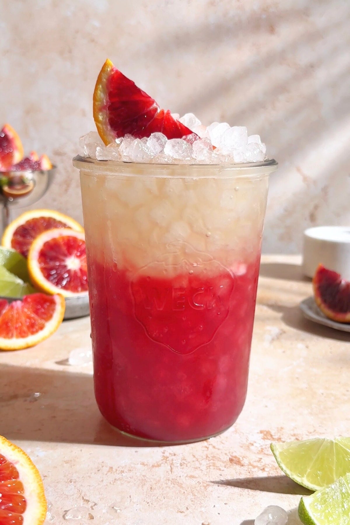 Blood orange homemade gatorade in a weck jar with a blood orang wedge on top