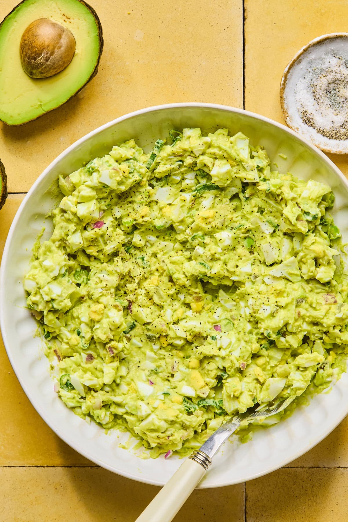 Avocado egg salad seasoned with salt and black pepper, mixed until slightly chunky and well combined.