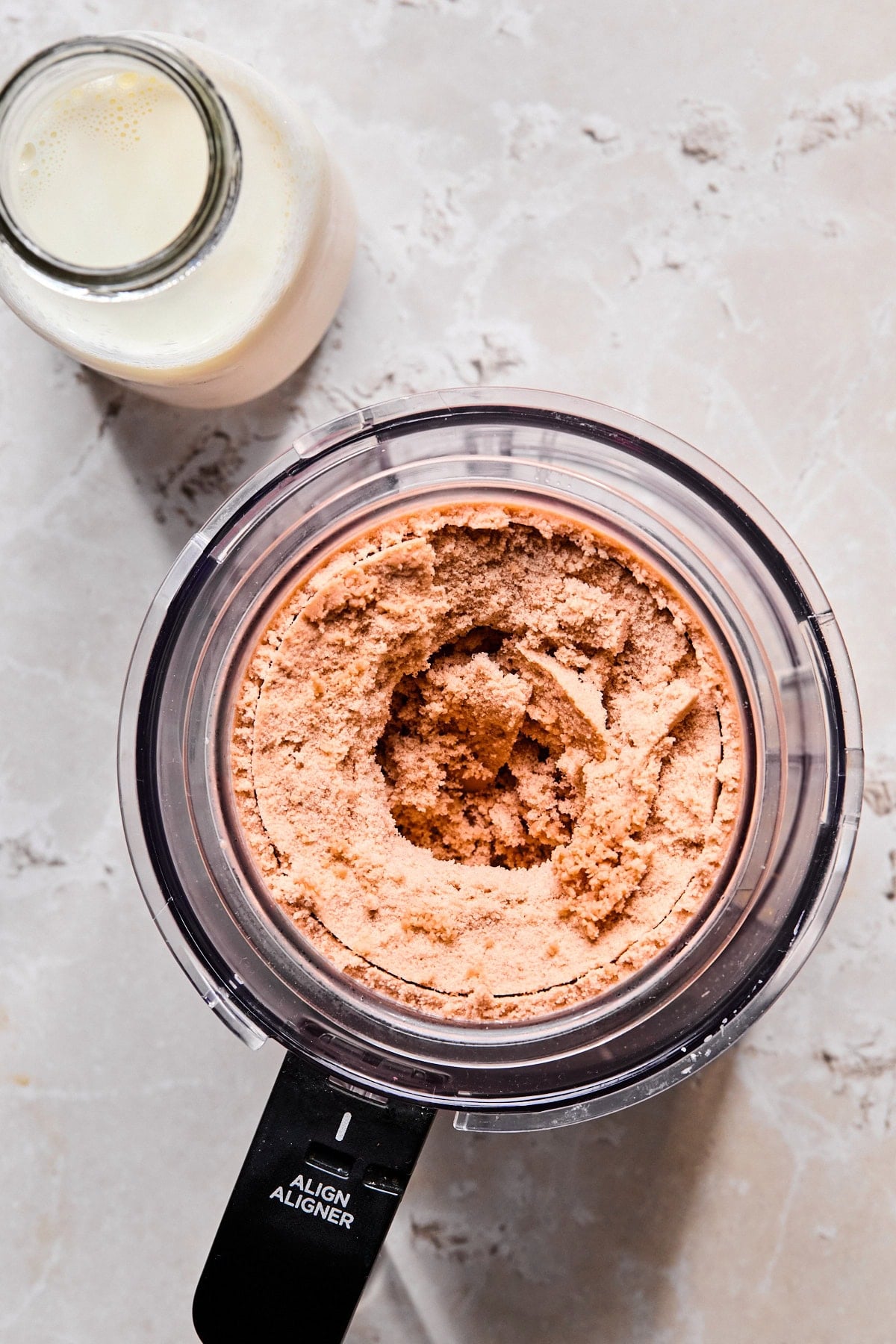 Frozen Ninja Creami pint placed into the Ninja Creami machine.