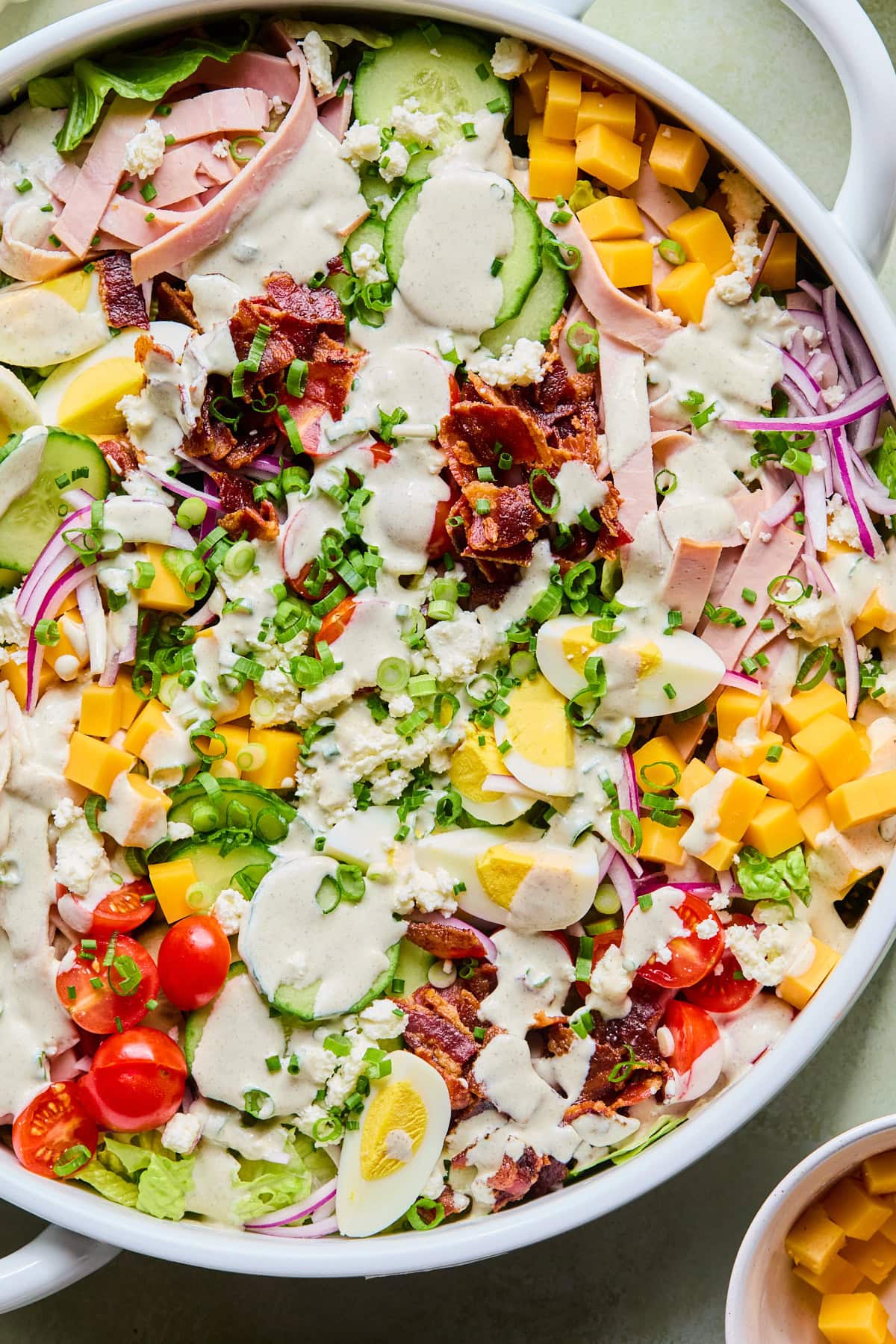 Close-up of assembled and dressed chef's salad recipe.