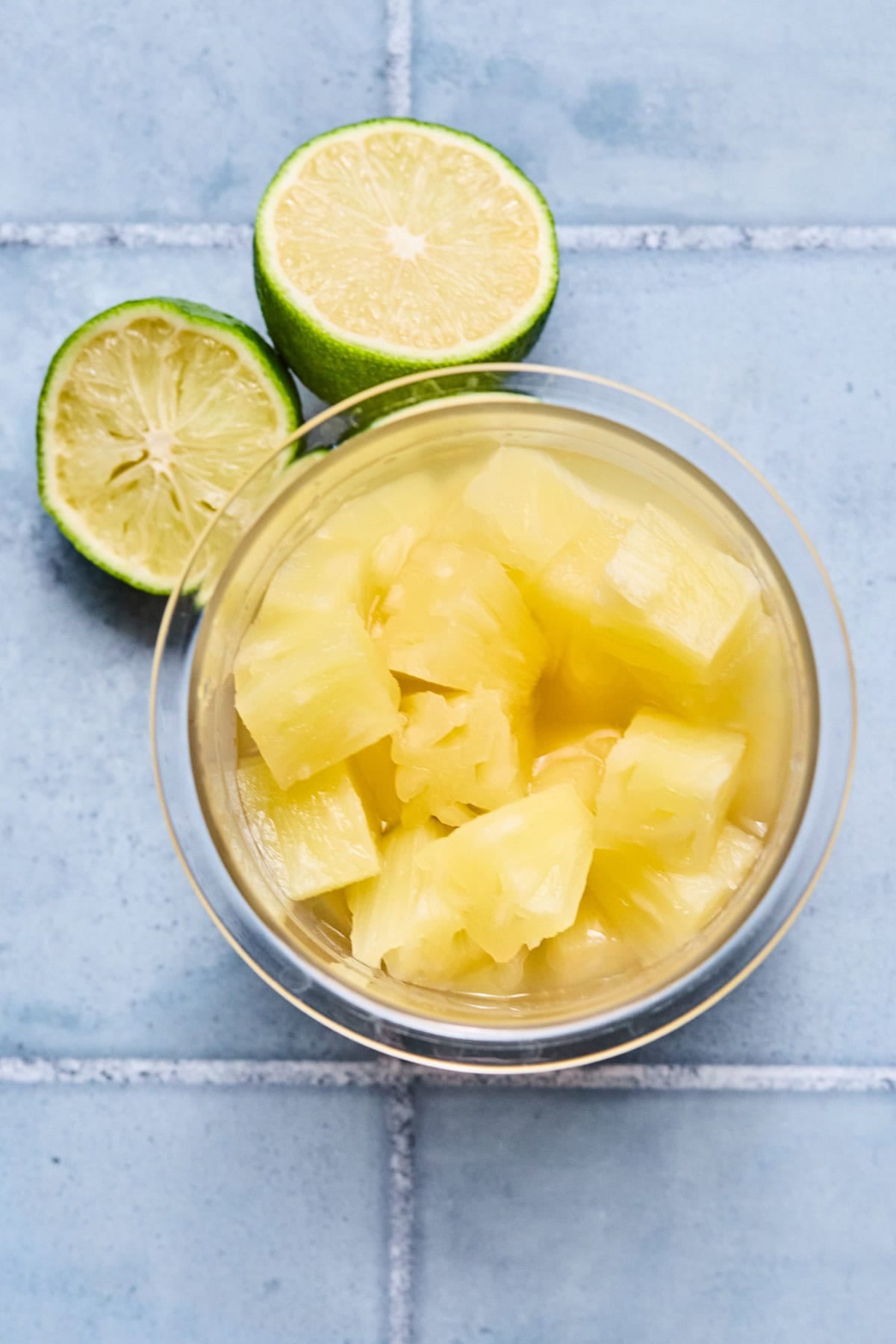 Ninja Creami pineapple sorbet recipe ingredients laid out on a gray countertop.