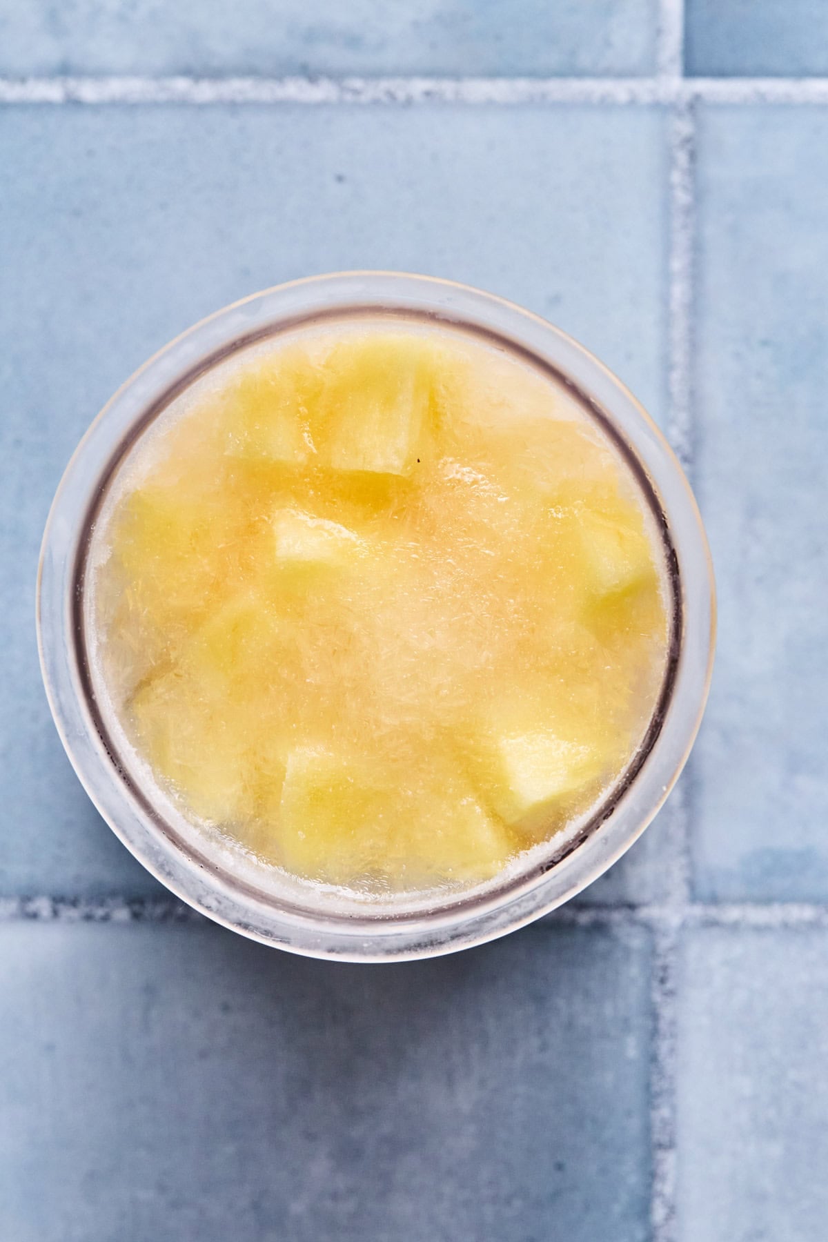 Pineapple sorbet recipe ingredients in Ninja Creami pint container.