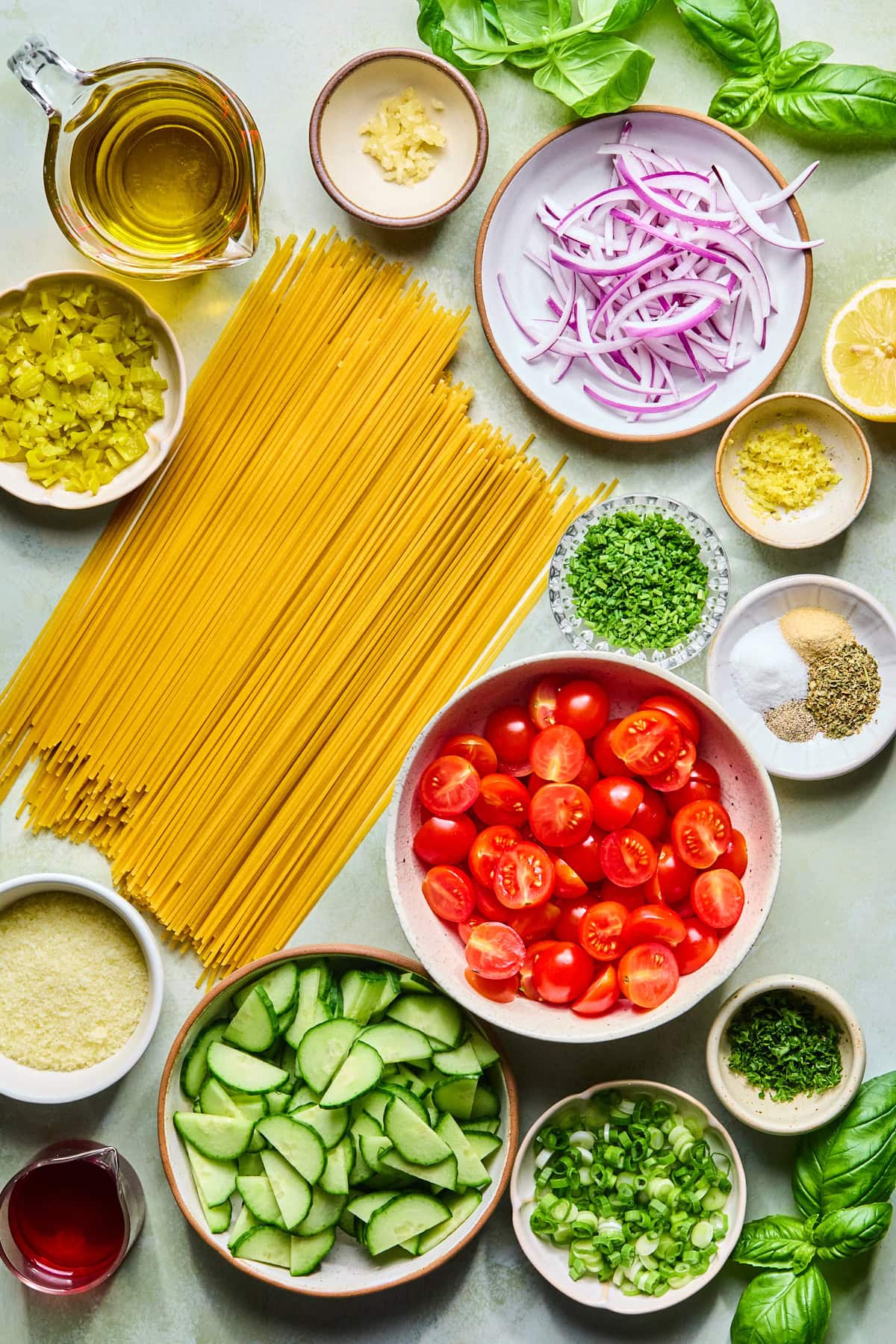 Spaghetti salad recipe ingredients laid out on a countertop.
