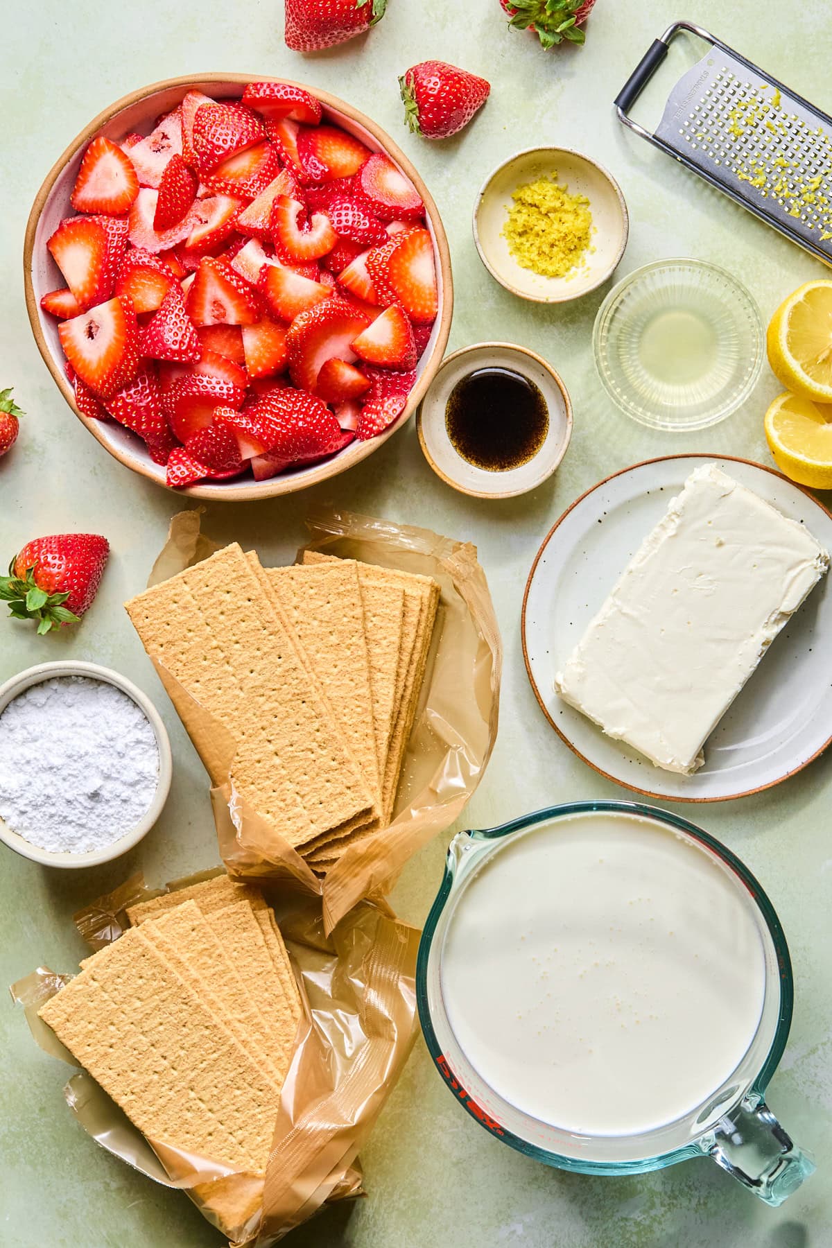 Strawberry icebox cake recipe ingredients laid out on a countertop.