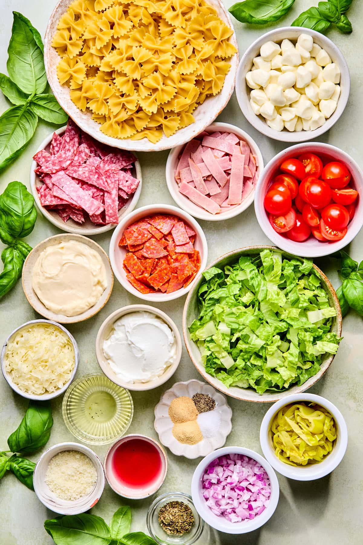 Italian grinder pasta salad recipe ingredients laid out on a countertop.