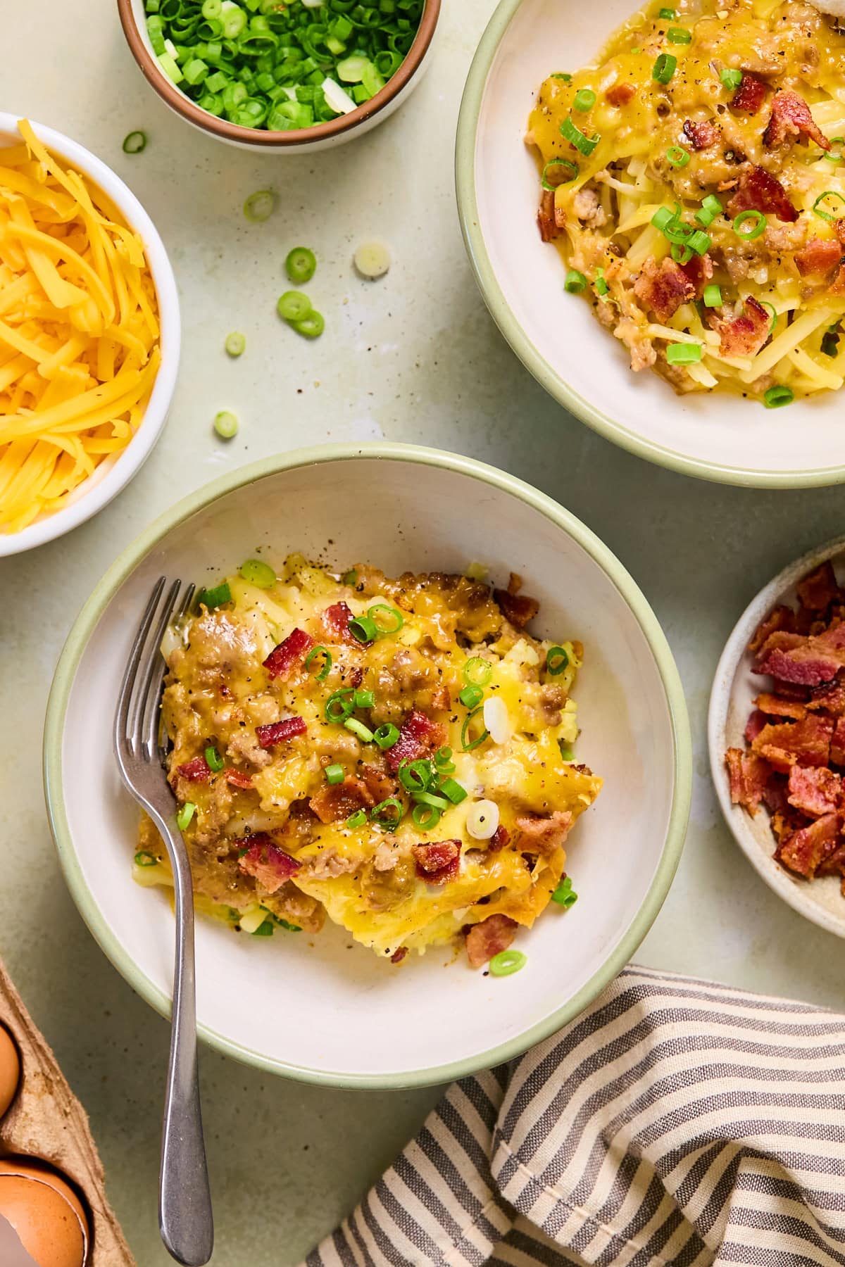 A portion of crockpot breakfast casserole on a plate with a fork.