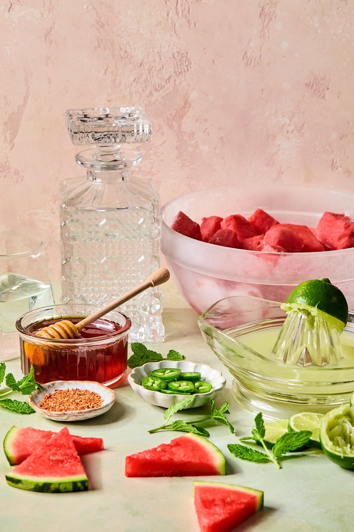 Watermelon margarita recipe ingredients laid out on a countertop.