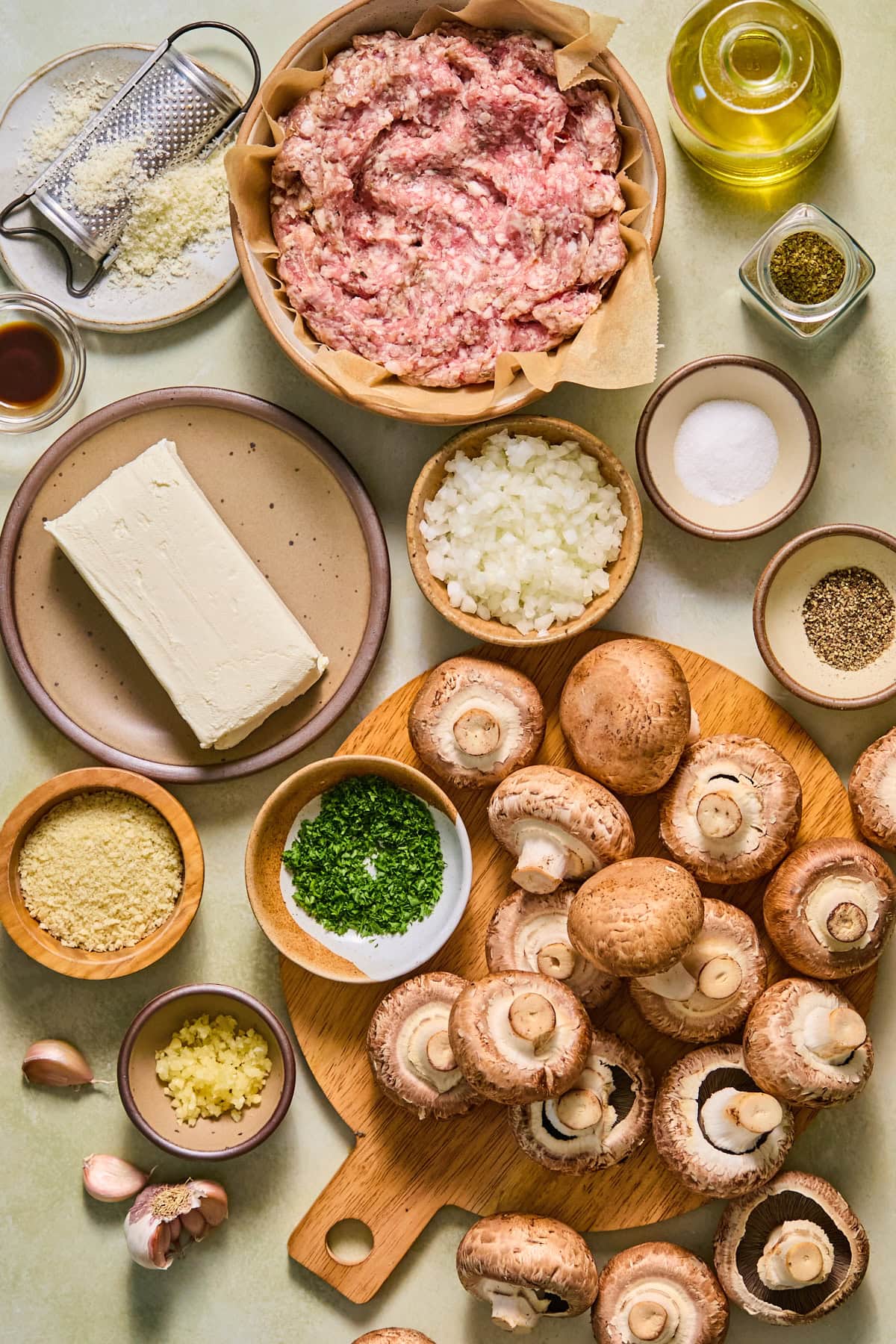 Sausage stuffed mushrooms recipe ingredients laid out on a countertop.